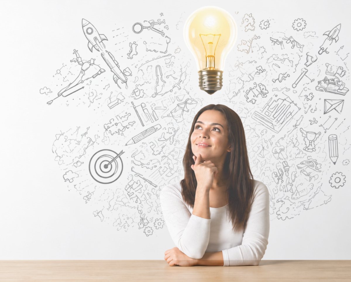 A professional pausing to think, with a lit light bulb above her