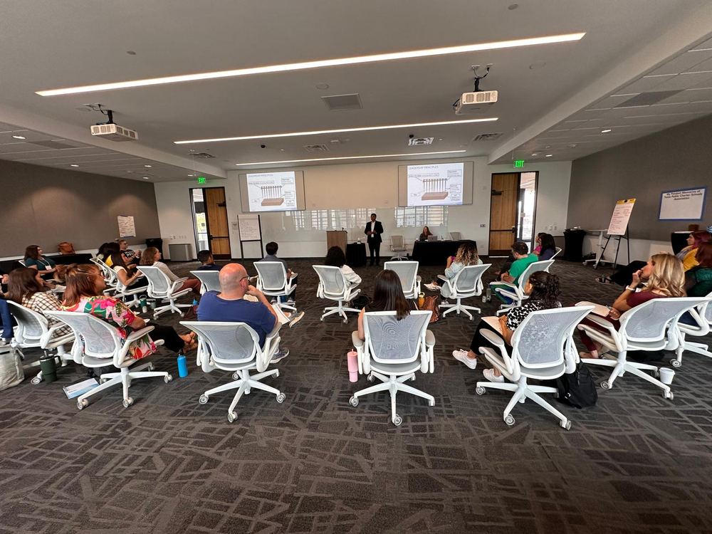A group of leaders seated together during a TLEX session